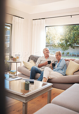 Buy stock photo Senior couple with coffee or tea and relax on sofa in their living room happy with retirement, real estate and lifestyle. Elderly people drink on couch or in lounge together while talking of marriage
