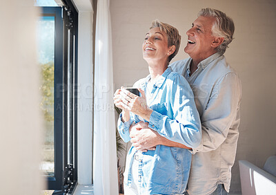 Buy stock photo Retirement, coffee and window with couple in the morning happy and laughing for health, wellness and love together. Hug, marriage and peace with elderly man and old woman drinking tea at home