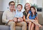 Parents, kids and family portrait in home lounge on sofa together to enjoy relax, bonding and fun quality time together. Happy parents, smile children and love with care, happiness and joy lifestyle