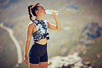 Fitness, runner and woman drinking water after running, training and cardio exercise outdoors in summer. Healthy, sports and thirsty athlete enjoying a bottle of liquid after workout in the sun 