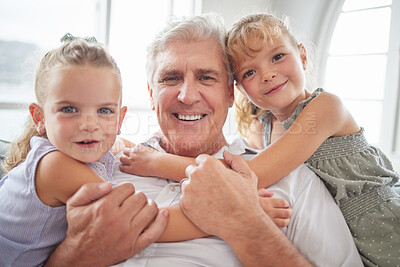 Buy stock photo Family, love and hug for grandpa from children while sitting together for a relationship portrait, smile and bonding at home. Happy girl kids or twin sisters with a senior man having fun and playing 