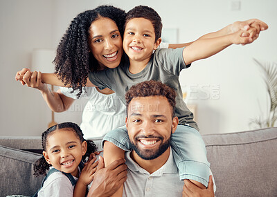 Buy stock photo Mother, father and children in family portrait and bonding in house, home or hotel living room. Smile, happy and fun girl, boy or kids playing airplane game with man, mexican woman or parents on sofa