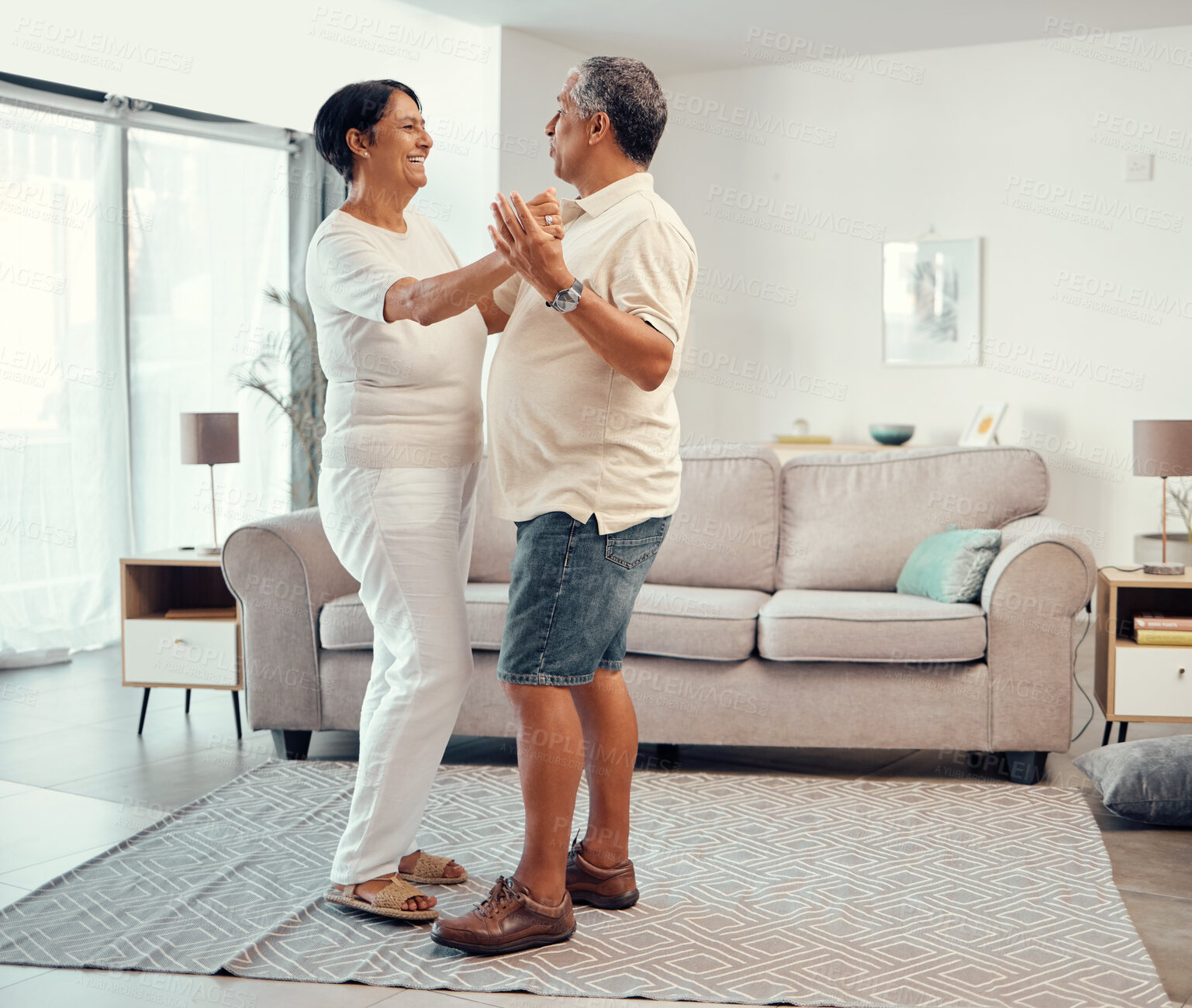 Buy stock photo Senior couple dancing in living room home for love, retirement or real estate. Dance together, celebration of marriage and elderly people smile. hug and share life with affection, freedom and care