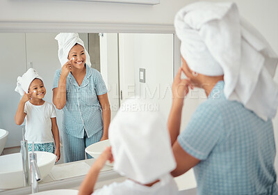 Buy stock photo Mother and girl doing skincare in the morning in the bathroom together. Black family in their home doing skincare routine, using products and lotion on their face. Family, face cream and facial care