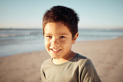 Buy stock photo Portrait, smile and happy boy on beach for summer holiday on nature background with ocean, sea or sand. Children, kids or face of youth in California travel location with earth landscape and blue sky