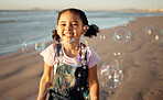 Beach, bubbles and a girl playing at sunset, having fun and enjoying an ocean trip. Freedom, energy and child running alone the sea, excited and playful while chasing bubble and laughing in nature