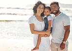 Black family on holiday, happy, at beach and smile in summer sun. Mother with her man, girl child on seaside vacation and stand in the waves by the ocean. Parents and kid relax, destress and unwind 
