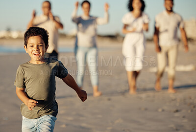 Buy stock photo Boy, running and beach with family, happy and cheerful while walking in the sand. Young male child by ocean, run on shore in summer, parents and grandparents have joyful time together in background