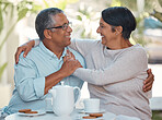 Senior couple laughing, drinking coffee and bonding in backyard cafe together, relax and cheerful outdoors. Elderly man and woman enjoying retirement and their relationship, sharing a joke and snack