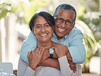 Portrait, elderly and couple bonding on a patio at home, hug, laugh and relax outdoors together. Love, retirement and happy seniors enjoying their relationship and bond, free time and fresh air 