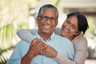 Buy stock photo Portrait of an elderly couple hugging and bonding outdoors, happy and relaxing in a yard or garden together. Senior man and woman enjoying retirement and a peaceful morning on a patio at home
