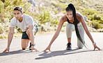 Sports race, fitness couple and ready to run asphalt road with competitive, fit and active runners for outdoor workout. Asian man and black woman sitting in position to start sprint, athlete training