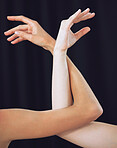Women, hands and ballet dance arms on black studio background in art for theatre, training or performance. Female ballerina hand and arm wrapped together of dancers or creative artists for theater