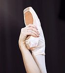 Dancer hand and foot on ballet shoe and hand, show posture and balance at dance class. Zoom of woman dancing in studio, practice or training  during professional performance or recital in a theater
