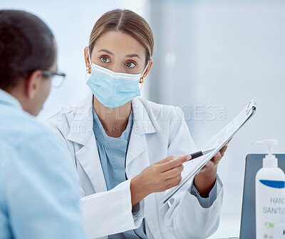 Buy stock photo Covid, woman and doctor with documents for consulting, records or patient help at hospital. Female, health and healthcare mask physician, form for vaccine agreement and pandemic safety regulations.
