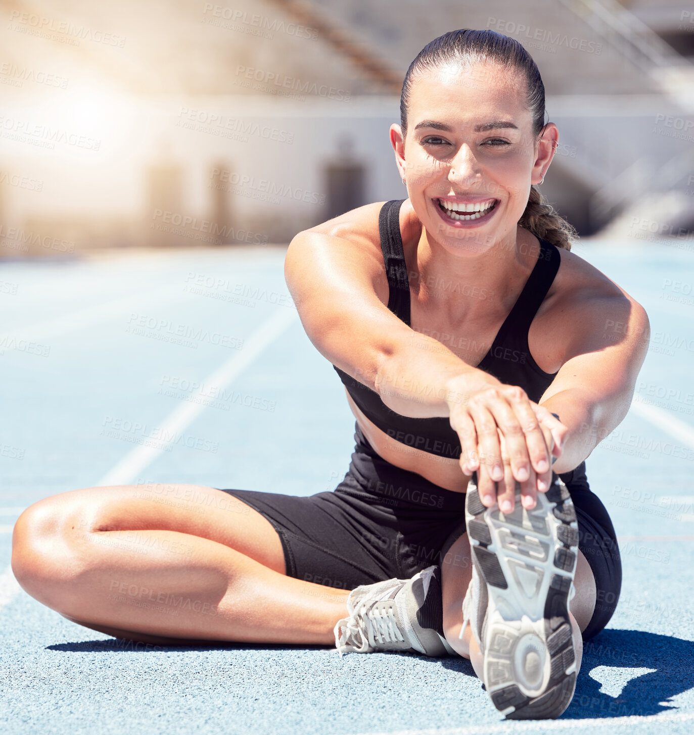 Buy stock photo Happy fitness or sports woman stretching at stadium in sunshine lens flare for healthy lifestyle and wellness motivation. Young athlete runner on ground outdoor in trainer shoes for exercise training