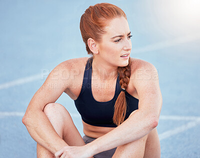 Buy stock photo Sports track, fitness and runner on break while training for marathon or olympic competition. Running, exercise and confused athlete sitting on floor while thinking and resting during cardio workout.