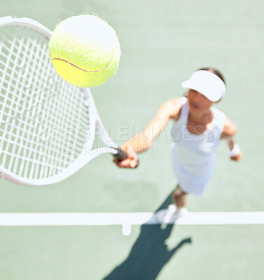 Buy stock photo Tennis woman on tennis court with a tennis ball in the air. Closeup of a young female athlete hitting the ball with a tennis racket to serve during a game or match. Training, fun and sports in action