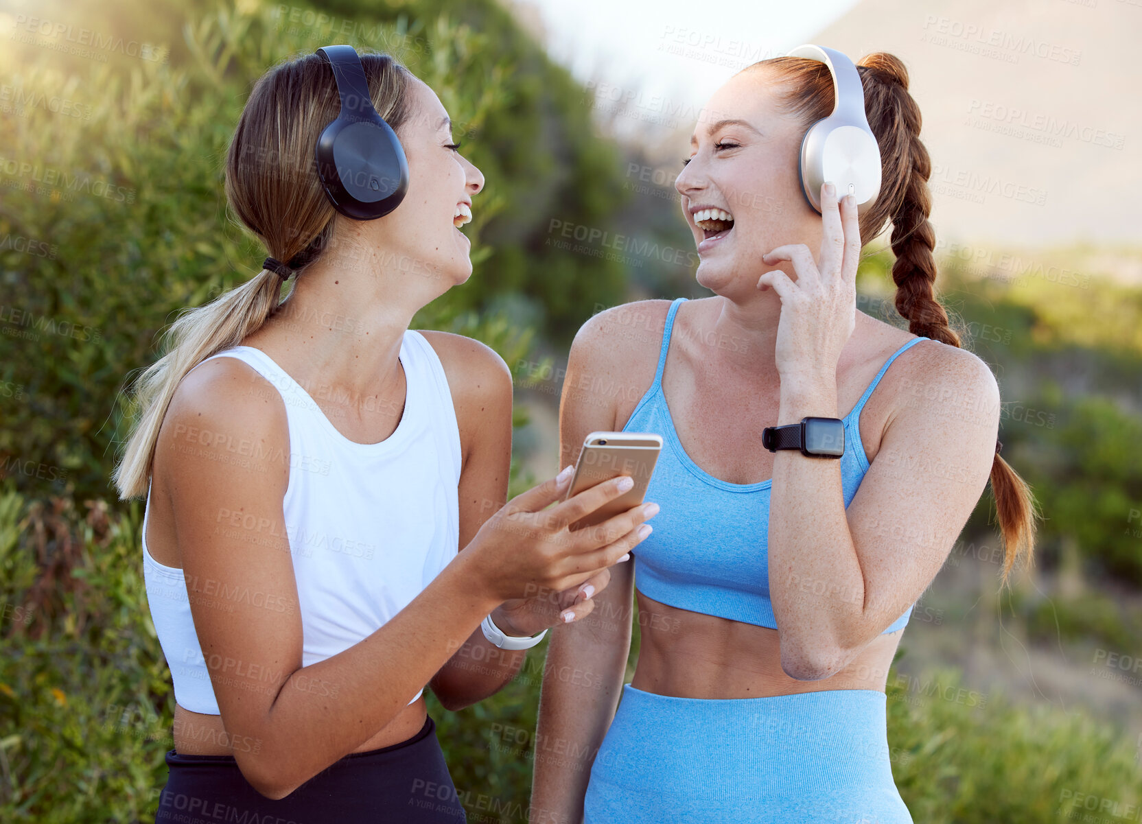 Buy stock photo Fitness music, happy nature and friends listening to radio with phone while training in summer, smile for podcast during workout and motivation for gym. Women with funny audio during outdoor exercise