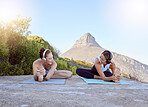 Yoga, music and friends with a sports woman and female athlete training outdoor for exercise, workout and fitness. Health, wellness and zen with two women exercising outside on a mountain in nature