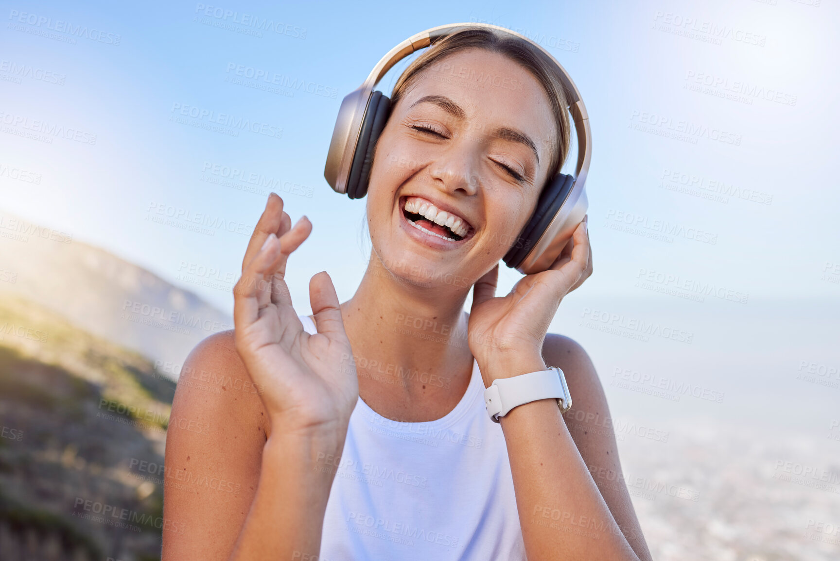 Buy stock photo Smile, laughing and hiking woman with headphones in fun exercise, fitness or workout in countryside mountains. Happy, face and comic athlete listening to music, radio or funny audio podcast in nature