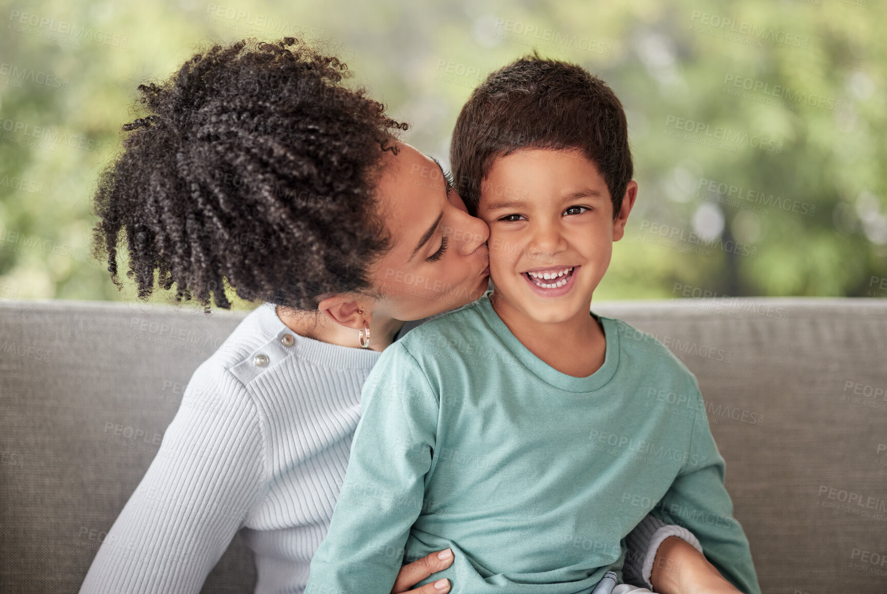 Buy stock photo Happy family, love and mother kiss son on a sofa, smile and relax in a living room together. Children, care and parent embracing child, happy and loving while enjoying motherhood with her sweet kid