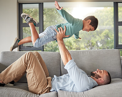 Buy stock photo Relax, family and dad balance on sofa for fun bonding time together in cozy house in Mexico. Support, trust and love of Mexican father holding young child in air with arms in living room.

