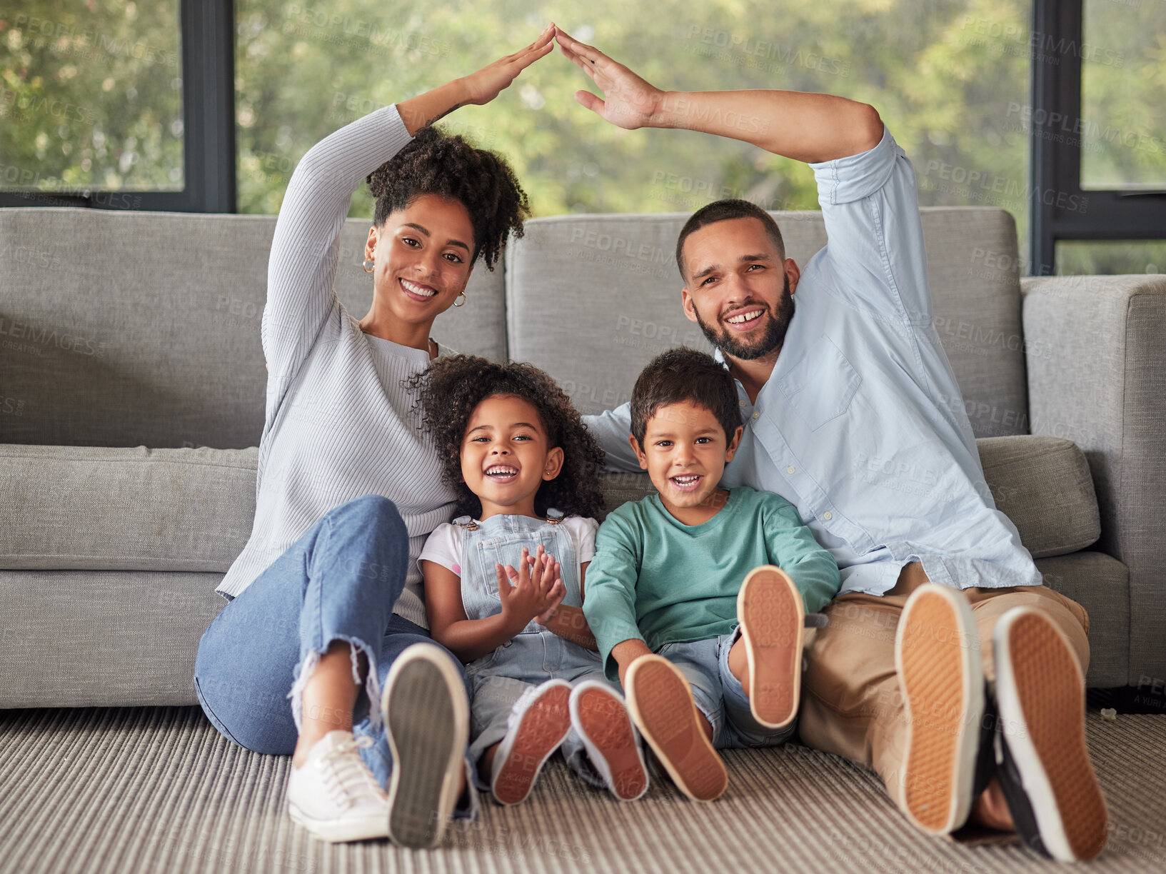 Buy stock photo Happy, family and home insurance with roof over kids for protection, family safety and care in their home. Portrait, mom and dad cover children loving, together and smile in living room on the floor 