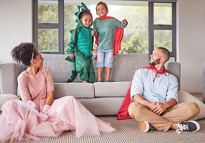 Buy stock photo Halloween, family and kids celebrate in costume happy, excited and bonding in living room. Love, parents and children on couch having fun, being playful and relax for fantasy party at family home.