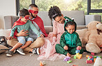 Happy family, superhero costume and toys in living room, kids playing and having fun together. Love, creative children outfit for halloween or fantasy game with caring dad, mom and children bonding.