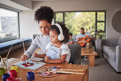 Buy stock photo Family painting, relax music and mother helping her child with art, creative school work and learning with pain at table of home. Girl with headphones for audio using paint for education with mom
