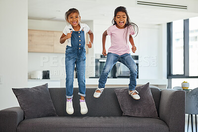 Buy stock photo Young friends, jumping and little girls on sofa in fun playful happiness together and excitement at home. Happy energetic kids playing on couch excited in joyful entertainment for free time leisure