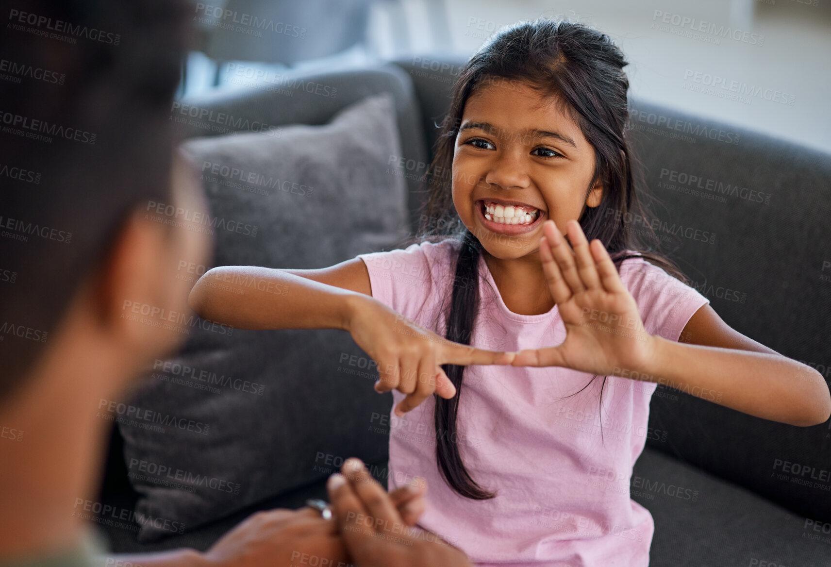 Buy stock photo Child, sign language and learning to communicate with deaf girl or parent while making fingers and showing visual symbols at home. Happy kid with hearing disability or loss sitting with a tutor