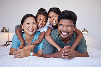 Buy stock photo Family, children and smile on bed for happy portrait together in house or bedroom. Mom, dad and kids in room, show love and happiness in while on holiday, vacation or own home in Jakarta, Indonesia