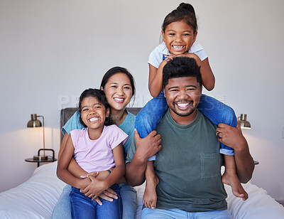Buy stock photo Happy family, portrait on bed in home bedroom and face smile bonding together. Love, happiness and caring Indian parents or father, mother and girls spending free time in comfort, support and care.