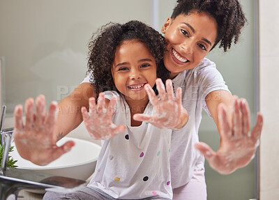 Buy stock photo Woman, child and washing hands in bathroom, cleaning to prevent germs and virus in home. Soap, water and hygiene, girl and mom from Brazil. Teaching, learning a clean morning routine and happy family