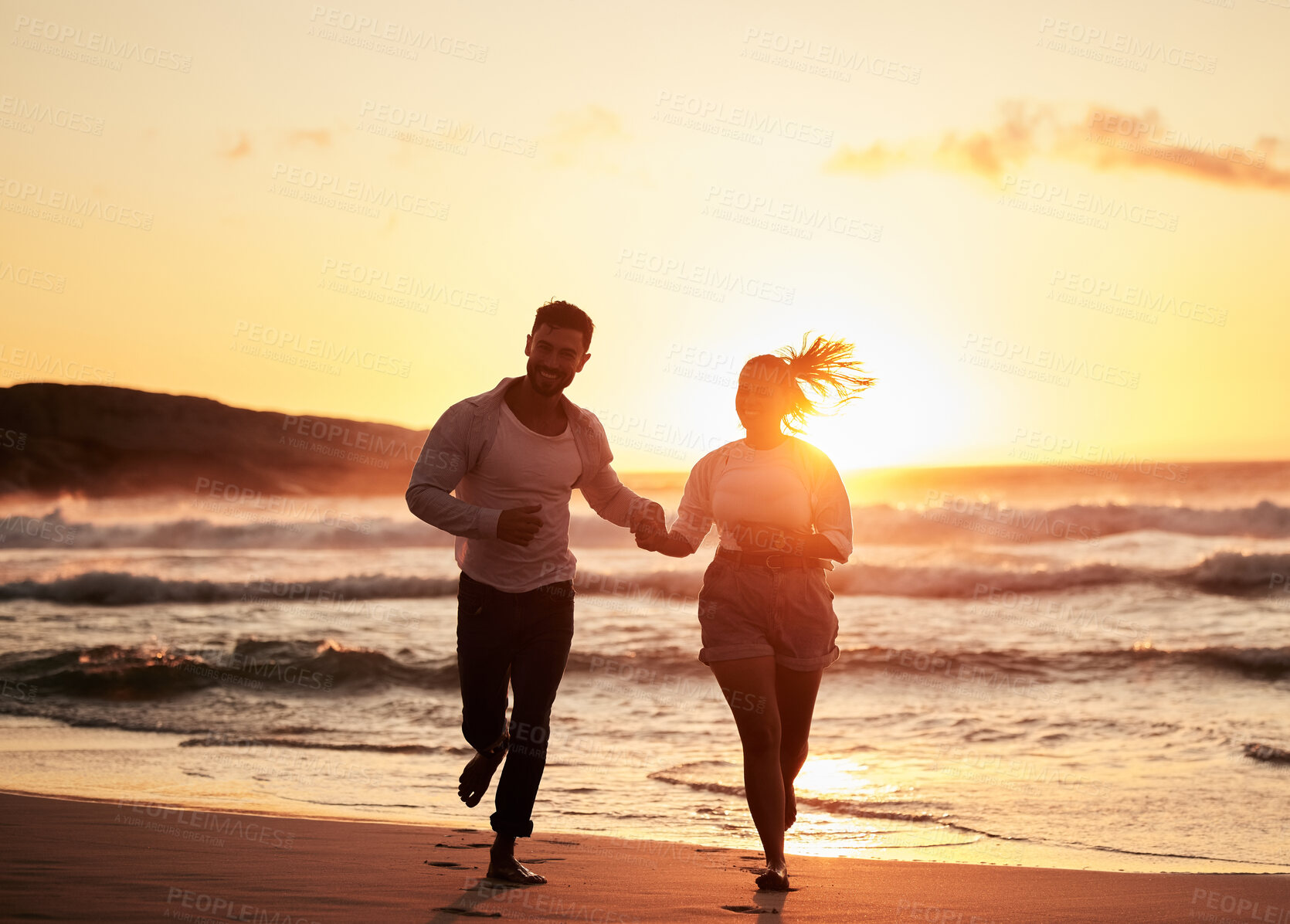 Buy stock photo Ocean, holiday and sunset, running couple on beach happy holding hands. Love, romance and man and woman run in evening sun. Romantic vacation, spend time together and playing in nature and fun at sea