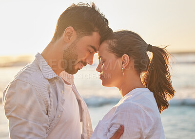 Buy stock photo Sunset, love and couple at the beach while on holiday or romantic summer honeymoon in greece. Happy, care and calm man and woman with romance, embracing and bonding in nature by the ocean on vacation