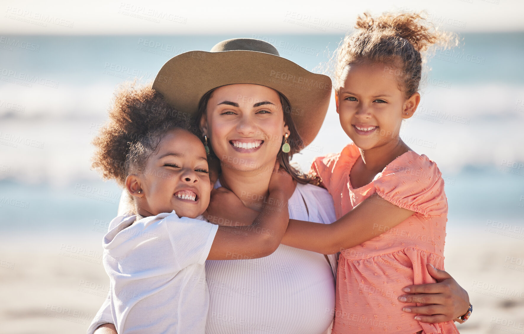 Buy stock photo Portrait of mother with child at beach smile, happy and hug with love. Latino woman with children, happy spend time as mother and daughters, on summer family holiday or travel vacation at an ocean
