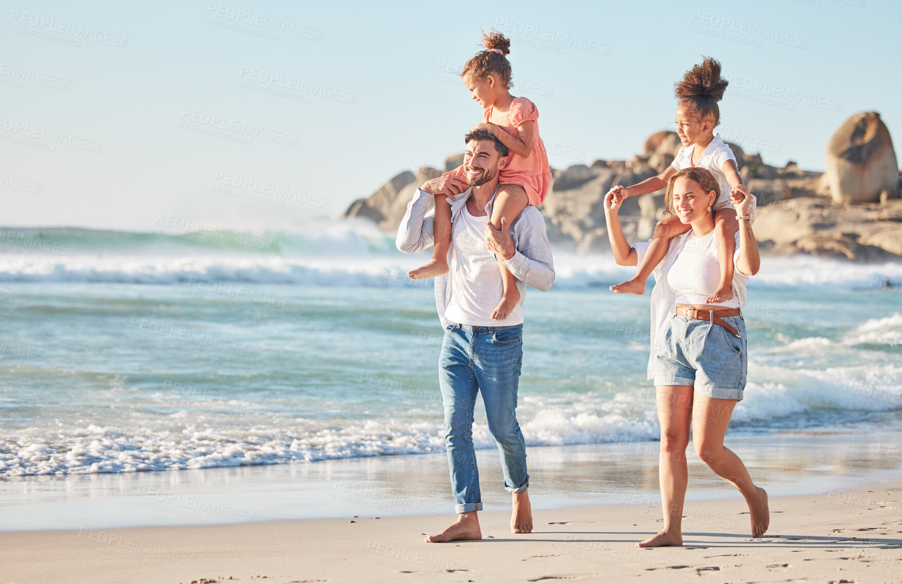 Buy stock photo Ocean, piggy back and couple with kids on a summer holiday at the beach. Love, family and fun, man and woman walking with children in sea sand. Vacation, time together and nature, happy in sunshine.