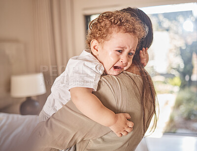 Buy stock photo Crying, sad and tears of baby with mom for comfort, safety and attention while hungry, upset or tired in a family home. Toddler boy child cry while in arms of caring woman babysitter, mother or nanny