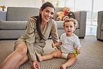 Mother, baby and smile in living room together on carpet in home, for playing and learning with toys. Child, mom and floor with dinosaurs to help kid with development of hands, mind or brain in house