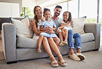 Parents, kids and happy family home portrait on living room sofa, couch and lounge to relax, quality time and fun together in Spain. Smile mom, dad and young girl children with love, support and care