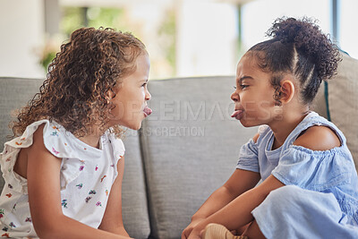 Buy stock photo Funny, crazy and silly kids enjoy playing and having fun together in home living room sofa. Latino children or sisters stick out tongue and enjoy childhood on cozy, couch and comfortable family home