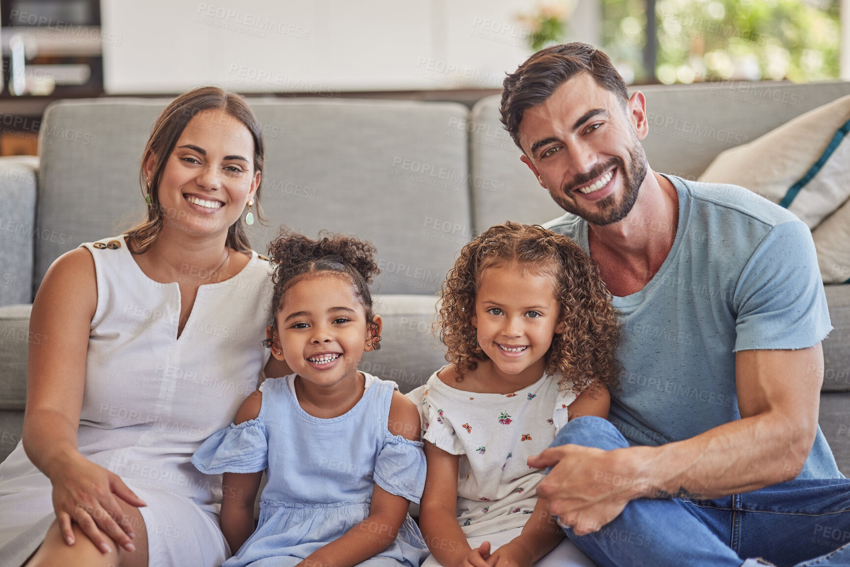 Buy stock photo Portrait, happy family in home living room and smile bonding together by sofa. Love, relax and caring parents or dad, mom and girls from Spain spending quality time, care and support in house lounge
