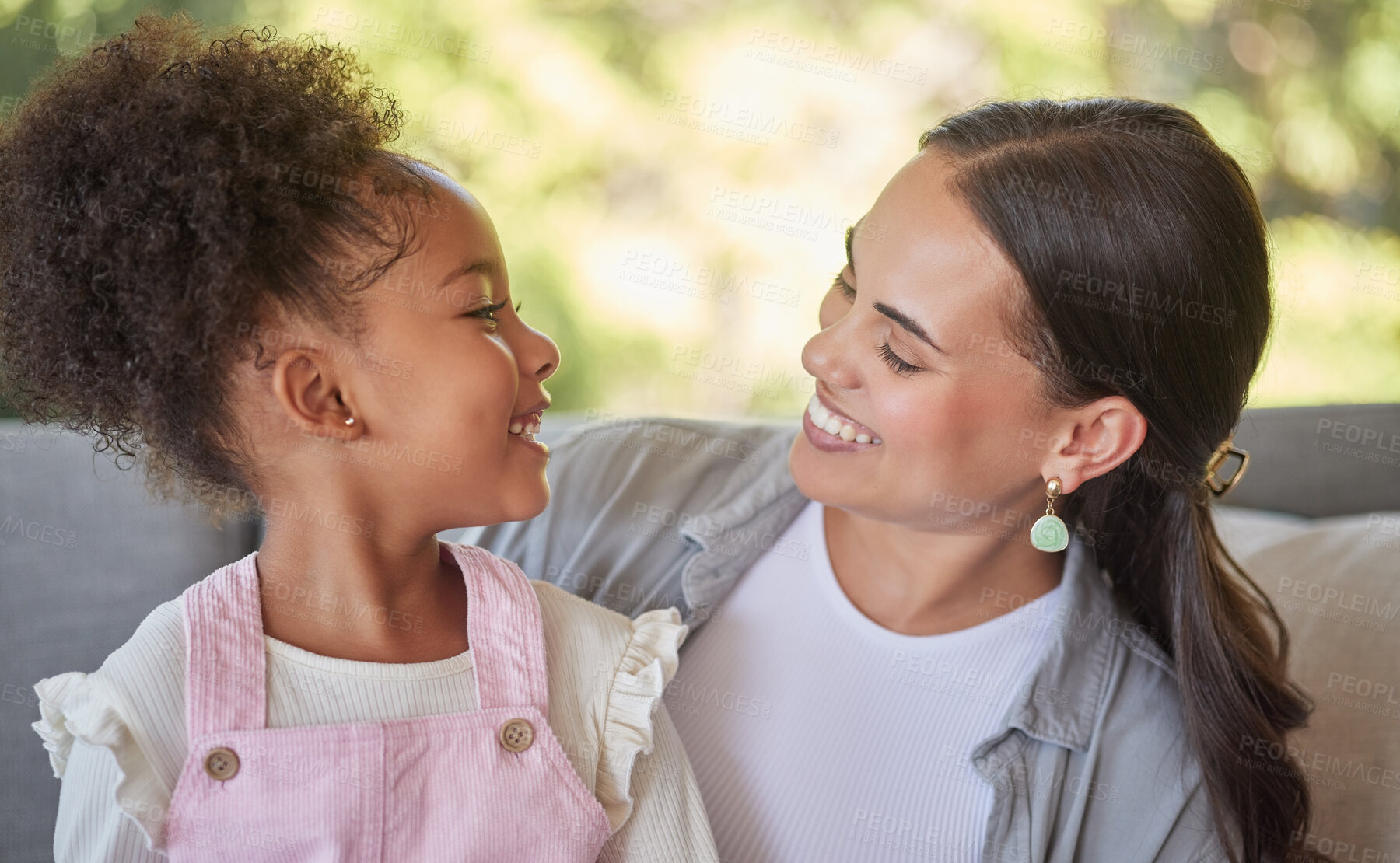 Buy stock photo Love, mother and smile with her girl as they relax and laugh on the couch at home. Sweet moment between latin woman and child while bonding, happiness and hug with care together at home as a family