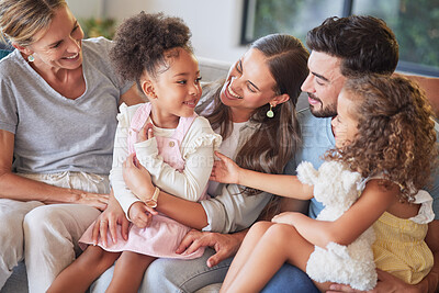 Buy stock photo Love, relax and happy family introduction on sofa, laughing and playing in a living room together. Parents, kids and grandmother talking and enjoying quality time with sweet interracial children