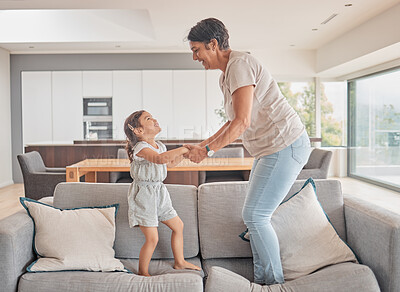 Buy stock photo Grandma jump and girl on sofa in fun play, happy together and excitement at home. Happy energetic family playing on couch excited in joyful entertainment for free time leisure with smile and love