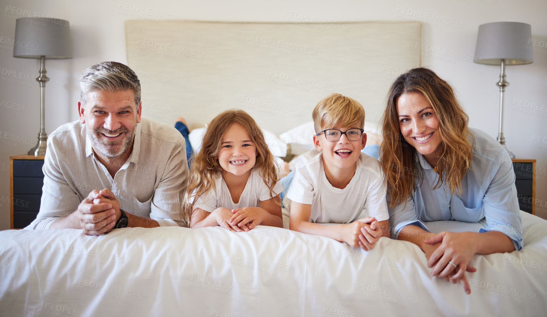 Buy stock photo Relax, family and bed portrait with happy parents of young children in cozy Canada holiday home. Love, care and support of mom and dad enjoying bonding leisure with young kids in bedroom.

