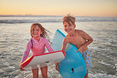 Happy children, beach and learning to surf for fun and bonding on bali summer vacation. Kids, boy and girl siblings on tropical holiday while surfing with board for water sports, splash and swim